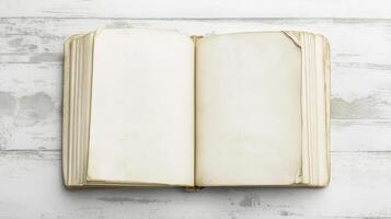 open book or magazine lying on a white wooden surface. The book appears to be blank, with no text or images on the pages. photo