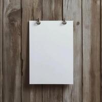 blank white paper hanging on a wooden wall. The paper is hanging from a metal hook on the wall, which is attached to the wooden planks photo
