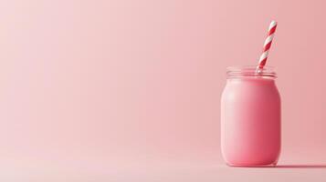 glass jar with a red and white striped straw. The jar is filled with a pinkish-red smoothie or milkshake. The background is a light pink color photo