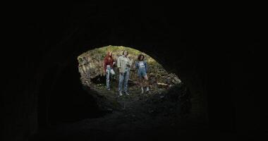 Friends are standing near the ruins. They are looking at the destroyed building. View from the building basement photo