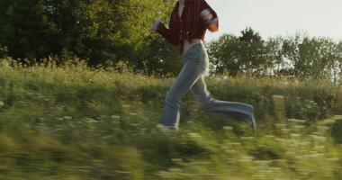 Three young friends are having fun and running around the field on a sunny summer day. Holidays in the countryside photo