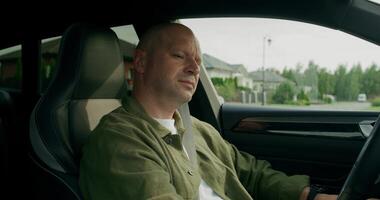 The man is driving the car, he is wearing a seat belt. view inside the car. photo