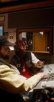 Listening to the song after recording in the studio. The sound engineer and the performer photo