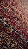 Persian carpet featuring elaborate geometric patterns, displaying rich textures and deep jewel-toned colors representing traditional Middle Eastern craftsmanship video