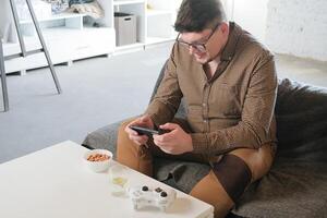 Caucasian man have live stream and win mobile game on the smartphone at home photo