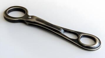 A wrench with a handle on a white surface photo