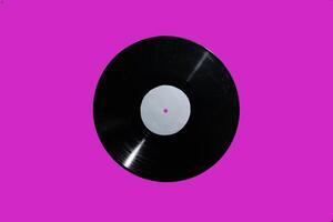 A stunning vintage vinyl record displayed against a bright pink background that captivates photo