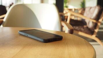 Exploring a cozy cafe setting with a smartphone on table video