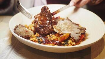 Enjoying a delicious plate of roasted meat and vegetables video