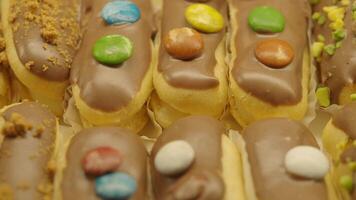 Delicious pastries with chocolate and colorful toppings video