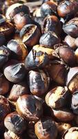 Roasted chestnuts at a winter market in a lively atmosphere video