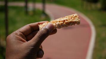 Enjoying a snack on a sunny park path during an afternoon video