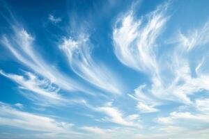 Beautiful wispy clouds create a stunning display against a bright blue sky during the afternoon photo