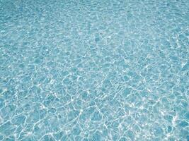 Serene, turquoise water shimmers under sunlight. Perfect for backgrounds, website headers, or travel brochures, this image evokes calmness and tranquility. photo