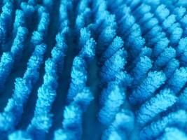 Abstract macro of a textured blue surface. Suggests cleanliness, hygiene, and softness. Perfect for backgrounds, textiles, or cleaning concepts. photo
