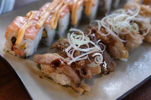sushi with pork with beef fried meat with salmon grilled red fish salmon asian cuisine experiments different types photo