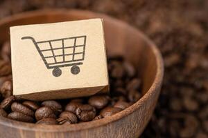 Box with shopping cart logo symbol on coffee beans, Import Export Shopping online or eCommerce delivery service store product shipping, photo