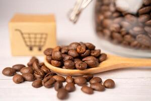 Box with shopping cart logo symbol on coffee beans, Import Export Shopping online or eCommerce delivery service store product shipping photo