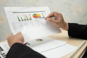 accountant working and analyzing financial reports project accounting with chart photo
