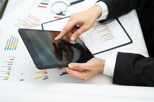 accountant working and analyzing financial reports project accounting with chart graph and calculator in office photo