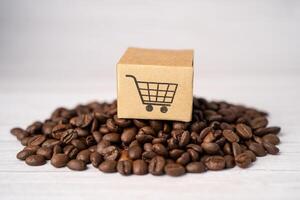 Box with shopping cart logo symbol on coffee beans, Import Export Shopping online or eCommerce delivery service store photo