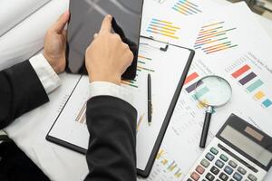 accountant working and analyzing financial reports project accounting with chart graph and calculator in modern office photo