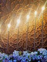 Carved wood and exquisite flowers, lights are meticulously arranged in an captivating visual display that beautifully highlights the perfect synergy between illumination and masterful craftsmanship. photo