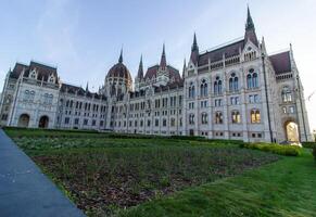 Detailed exterior views of the Hungarian Parliament Building in Budapest showcasing neo-Gothic architecture, pointed spires, arches, and ornate stonework photo