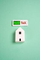 Tax paid for the house. The indicator lights up green, indicating successful payment of the property tax. Tax season. Financial responsibility. Avoid fines. Reduce expenses, get a refund. photo