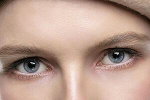 Blue eyes of a girl close up. Part of the face photo
