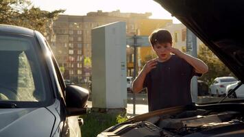 Young boy, under age of majority, illegally took his father's car without permission and caused accident when he crashed into another vehicle. boy is now assessing damage and is scared and upset about what has happened. video