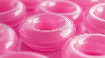 Glossy pink gummy rings image render 3d. Chewing candies display. Tasty fruity jelly bagels arranged on tray background realistic graphic. Conceptual idea, visual storytelling photo