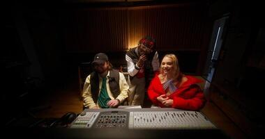 The sound engineer talks to the musicians after recording the song in the studio. photo