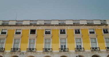 Bottom view of an old yellow building in the style of classicism photo