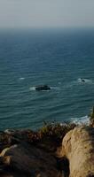 View from the top of the coastal cliff to the sea photo