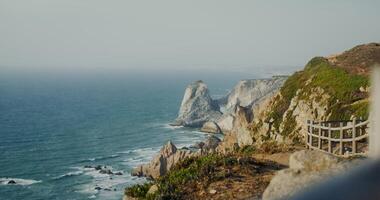 View of the sea washing the rocky shores and ledges. View from the top of the mountain photo