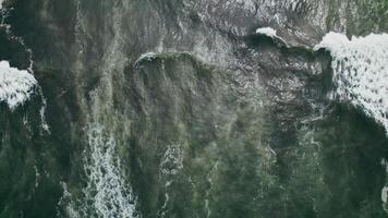 Drone footage showing frothy ocean waves in motion during high tide. Nothing but waves in the scene. photo