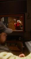 Working in a recording studio. The sound engineer uses an audio mixer. The singer sings into the microphone photo