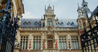 Facade of the beautiful Benedictine Palace in F camp. Fancy spires and turrets on the roof of the palace in an original style combining Gothic and Renaissance. photo