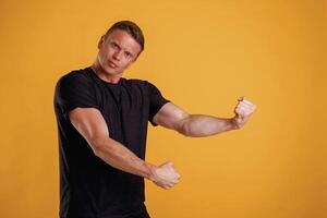Strong arms, showing muscles. ,,,Man is against background in the studio photo