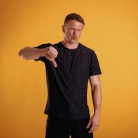 Unsatisfied, showing dislike. Man ,,is ,against, background in the studio photo