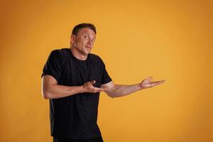Confused,, don't ,know ,what to do. Man is against background in the studio photo