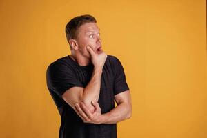 Scared, feeling ,stressful.,, Man is against background in the studio photo