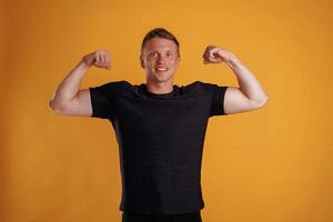 Strong arms, showing muscles.,, Man is against background in the studio photo