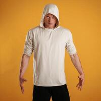 Dangerous, in hoodie. Man is against background in the studio photo