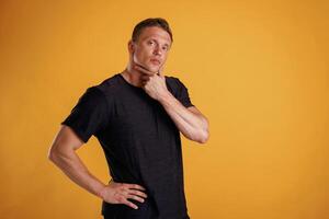 Thoughtful, facial ,,,expression. Man is against background in the studio photo