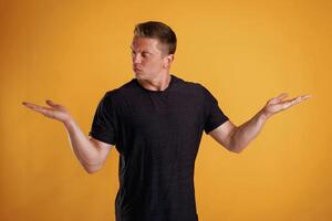 Choice of two different things, copy space. Man is against background in the studio photo