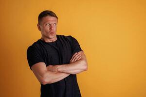 Standing with, arms crossed... Man is against background in the studio photo