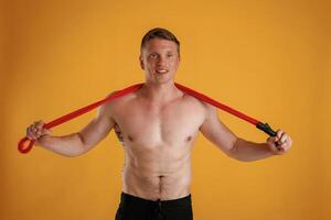Red jump ropes, endurance ,,,and ,sport concept. Man is against background in the studio photo