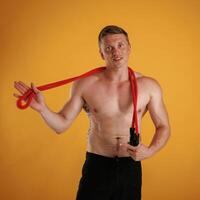 Red jump ropes, endurance, and, sport,, concept. Man is against background in the studio photo